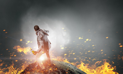 Naklejka premium Businessman throwing petrol bomb . Mixed media