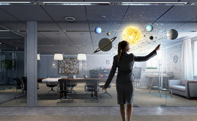 Businesswoman in her office . Mixed media