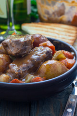 Hearty beef stew with carrot, celery, shallot and potato, vertical