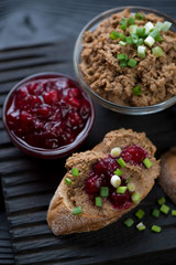 Chicken liver pate with cranberry sauce and green onion, closeup