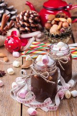 Hot chocolate with marshmallows and spices on christmas table