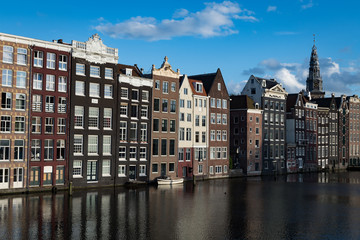 Obraz premium Coverted warehouses and the spire of St Nicholas church, Amsterdam, Netherlands