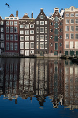 Fototapeta premium Crooked warehouses and their reflections, Amsterdam, Netherlands