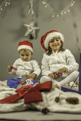 Kids with Santa hat portrait shot in studio. Christmas elements