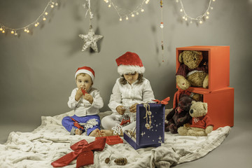 Kids with Santa hat portrait shot in studio. Christmas elements
