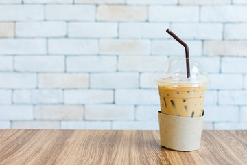 A glass of iced coffee on table on white background