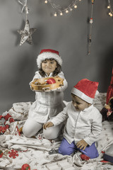 Children with Santa hat looking up. Christmas elements