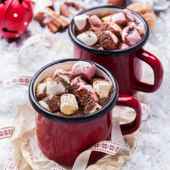 Hot chocolate with marshmallows and spices on christmas table