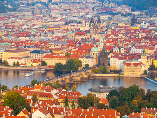 Naklejka premium Aerial view of cityscape with Charles Bridge over Vltava River and Old Town of Prague from Petrin Hill Observation Tower in the sunny evening, Prague capital city of Czech Republic, Europe. UNESCO
