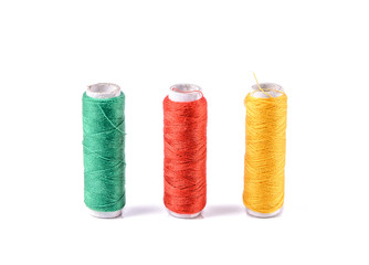 Colorful bobbin thread on white background