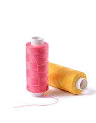 Colorful bobbin thread on white background