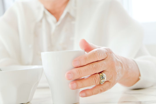 Close up image of senior women with drink, meal time 