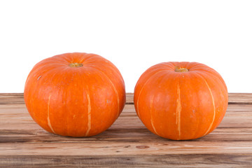Orange pumpkins on a wooden table