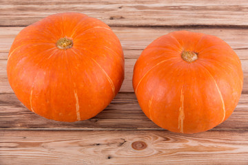 Orange pumpkins on a wooden table