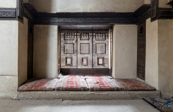 Interleaved wooden window (Mashrabiya) with built-in couch, and an embedded wooden cupboards at El Sehemy house, an old Ottoman era house in Cairo, originally built in 1648