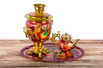 Traditional Russian samovar and a teapot on a tray on white background