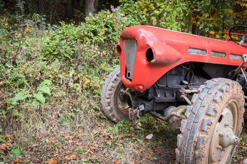 Old and broken tractor in forest