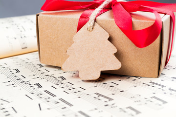 Christmas present with label and twine on music sheet