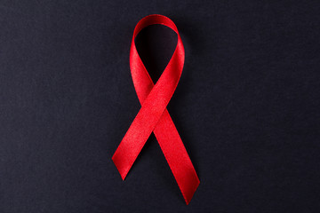 Red ribbon as symbol of aids awareness on white