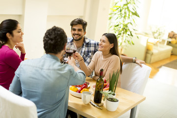 Young people sitting by the table