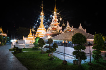 Twin pagoda in the temple with light at night