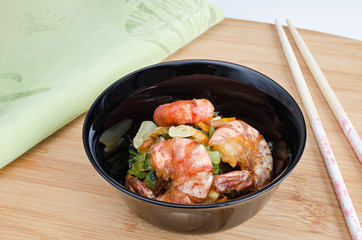 Seafood in a small bowl on wooden background. Selective focus.