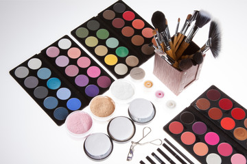 Make up kit on white background. Professional cosmetics. Eye-shadow,rouge,powder.