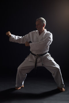 Senior man practicing karate.