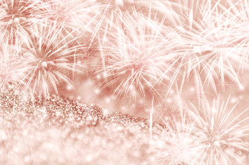 Silver and Rose gold fireworks and bokeh on gliter paper at New Year and copy space. Abstract background holiday.
