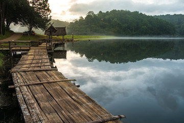 Wooden bridge across the mirror lake