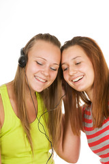 Two teenage girls listening to music