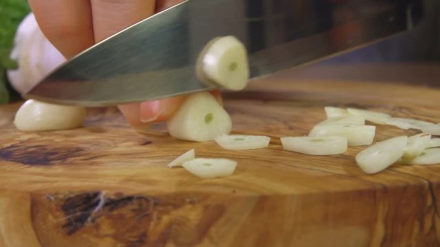 Cutting garlic on a wooden cutting board