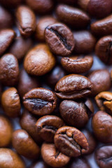 Close up beans on a white background. Coffee on the entire screen for the background. Roasted coffee beans brown. Lots of coffee in high definition.
