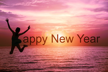 Happy new year card 2017. Silhouette of happy girl in swimwear jumping on tropical sea with sunset sky background. Kid jumping as part of the word Happy New Year with ocean and sunrise background.