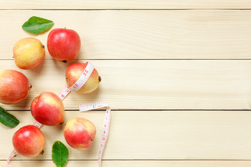 Top view red apple napkin,knift,basket,measuring tape on wooden.