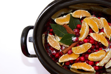 Cranberry sauce with oranges, cinnamon and bay leaf simmering in