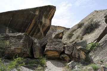Landscape in Gobustan Rock Art Cultural Landscape Reserve in Azerbaijan, with rocks among grass.