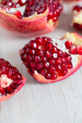 pomegranate seeds on wooden surface