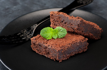 chocolate cake brownie on a black plate