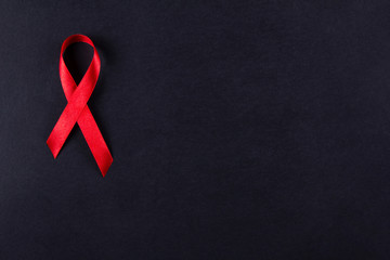 Red ribbon as symbol of aids awareness on white