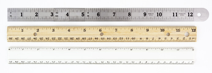 Metal, wood, and plastic rulers. Horizontal.