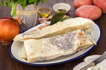 salted cod fish on dish and potato