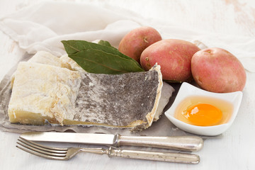 cod fish with potato on wooden background