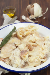 dry cod fish on dish on wooden background