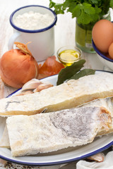 salted codfish on dish with powder and onion