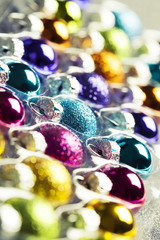 Bright multicolored christmas balls in rows, toned