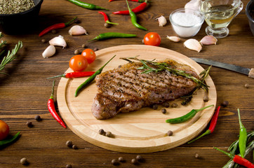 rare steak wooden cutting board garlic spices