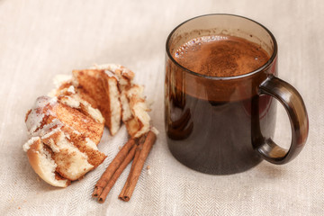 Freshly cinnabon French bun with cinnamon and coffee, selective focus