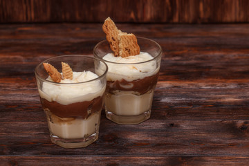 Vanilla chocolate pudding dessert with a cream filled sandwich cookie