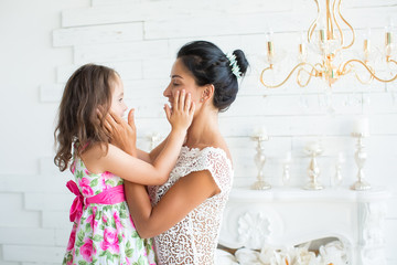happy family. Mother and baby daughter plays, hugging, kissing a